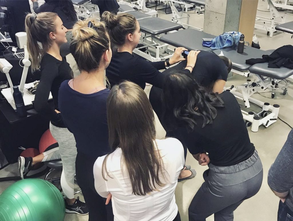 physiotherapy students practice using a scoliometer to assess for scoliosis